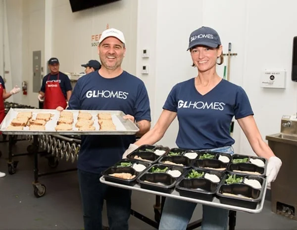 Misha Ezratti volunteering at a Feeding South Florida hunger relief event.