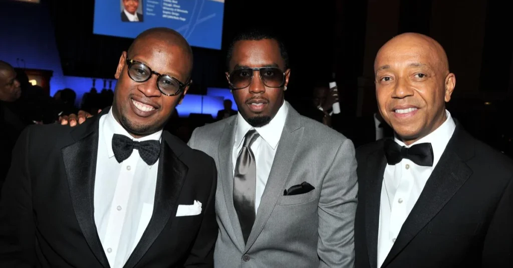 Three iconic music executives—Andre Harrell, Sean Combs, and Russell Simmons—posing together in formal tuxedos at an industry event.
