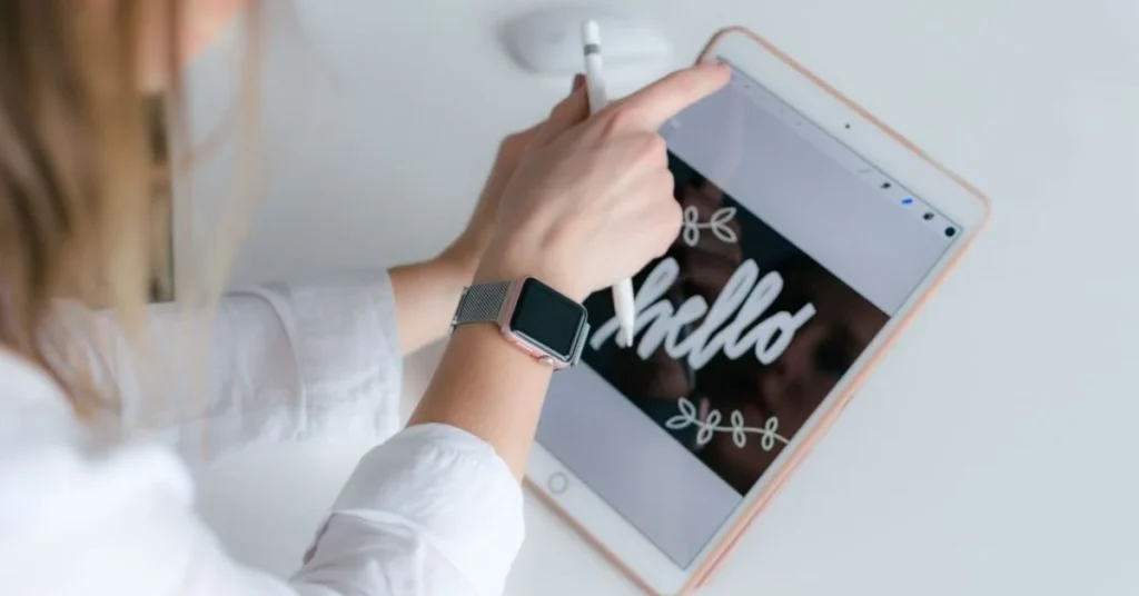 Woman using Apple Pencil on iPad to write with digital planner app open