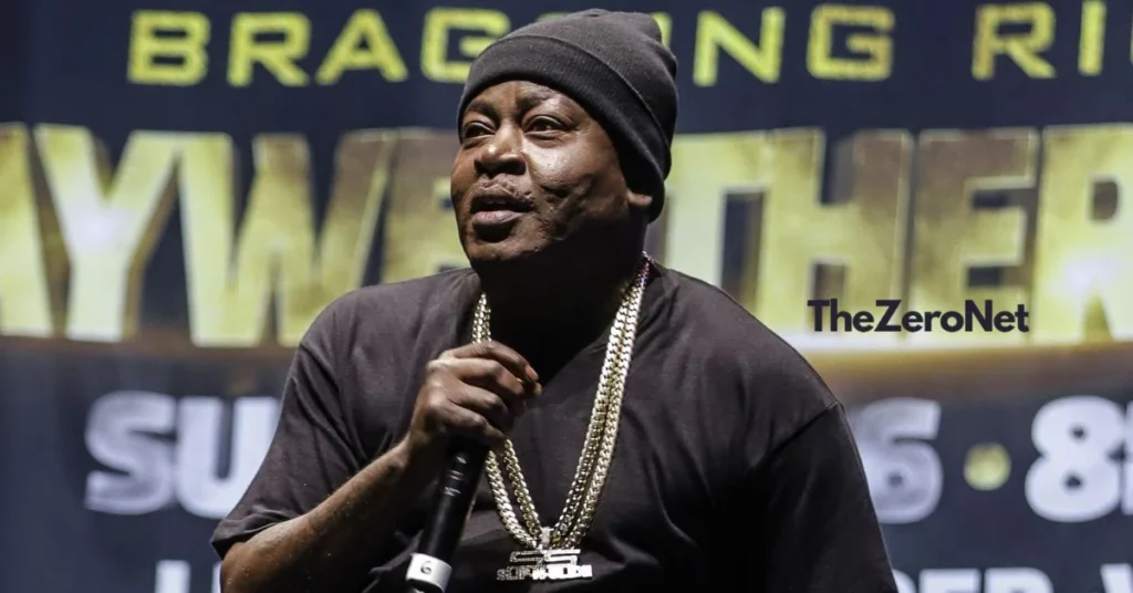 Rapper Trick Daddy holding a microphone and performing live on stage at a high-profile boxing event weigh-in.